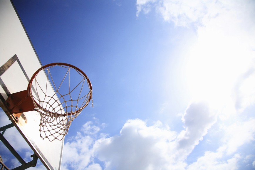Looking up to the sky with basketball hoop