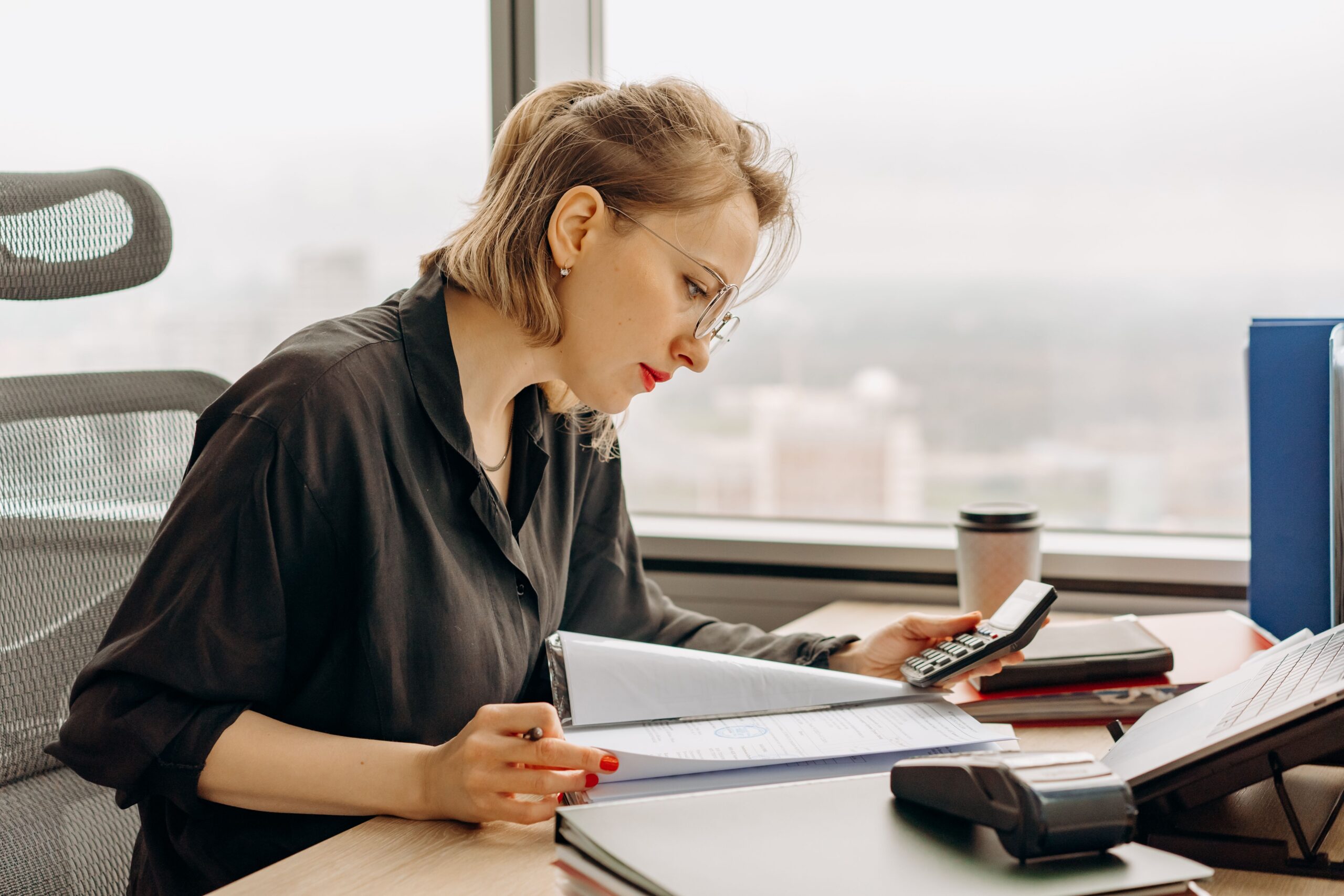 Year-end tax planning for business owners with financial documents and a calculator on a desk